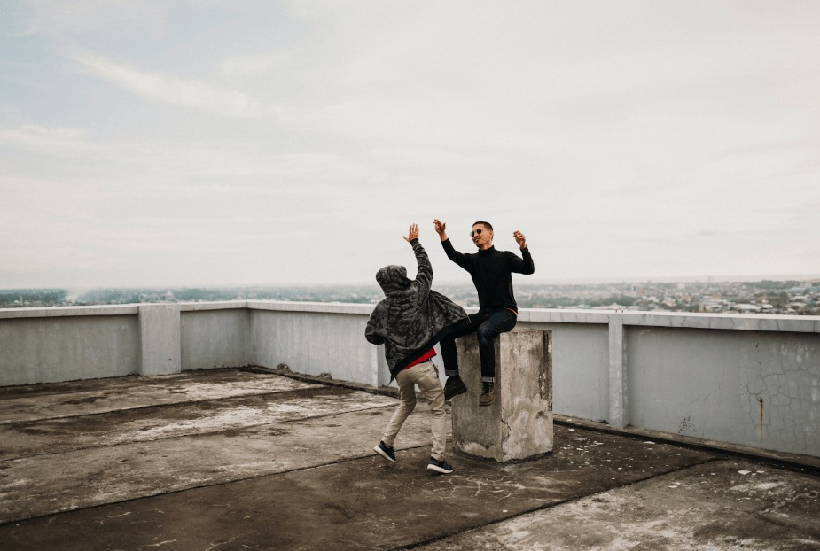 People high fiving on a roof terrace