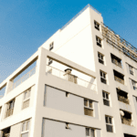 A photo of a white-facaded apartment building