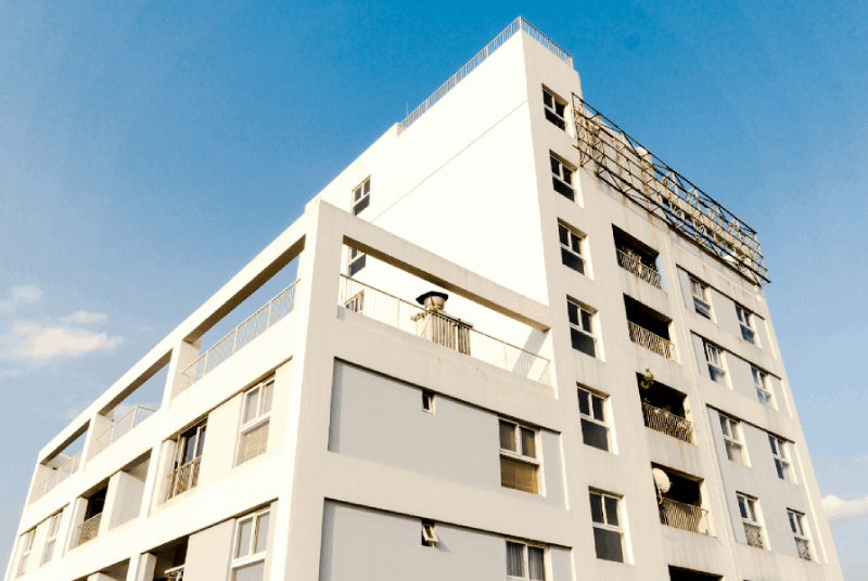 A photo of a white-facaded apartment building