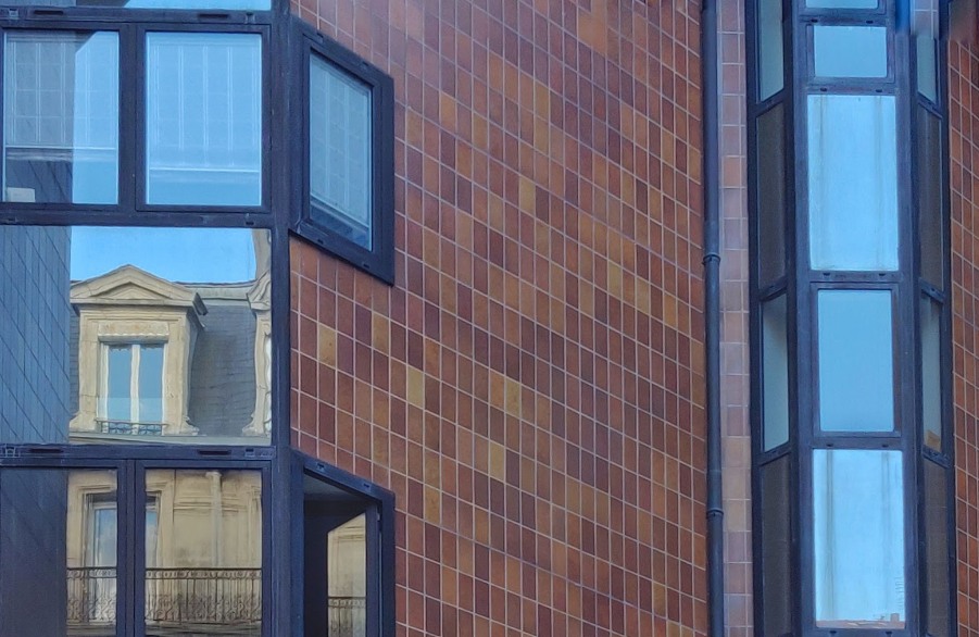 a building with windows and a pipe