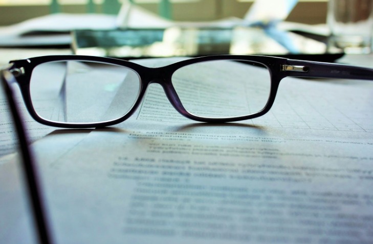 a pair of glasses on a piece of paper